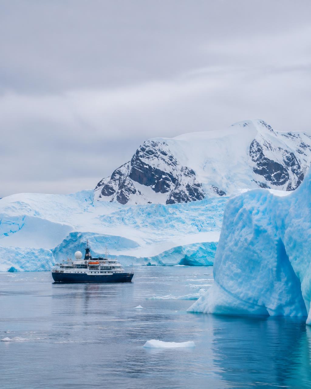 An expedition ship among glaciers