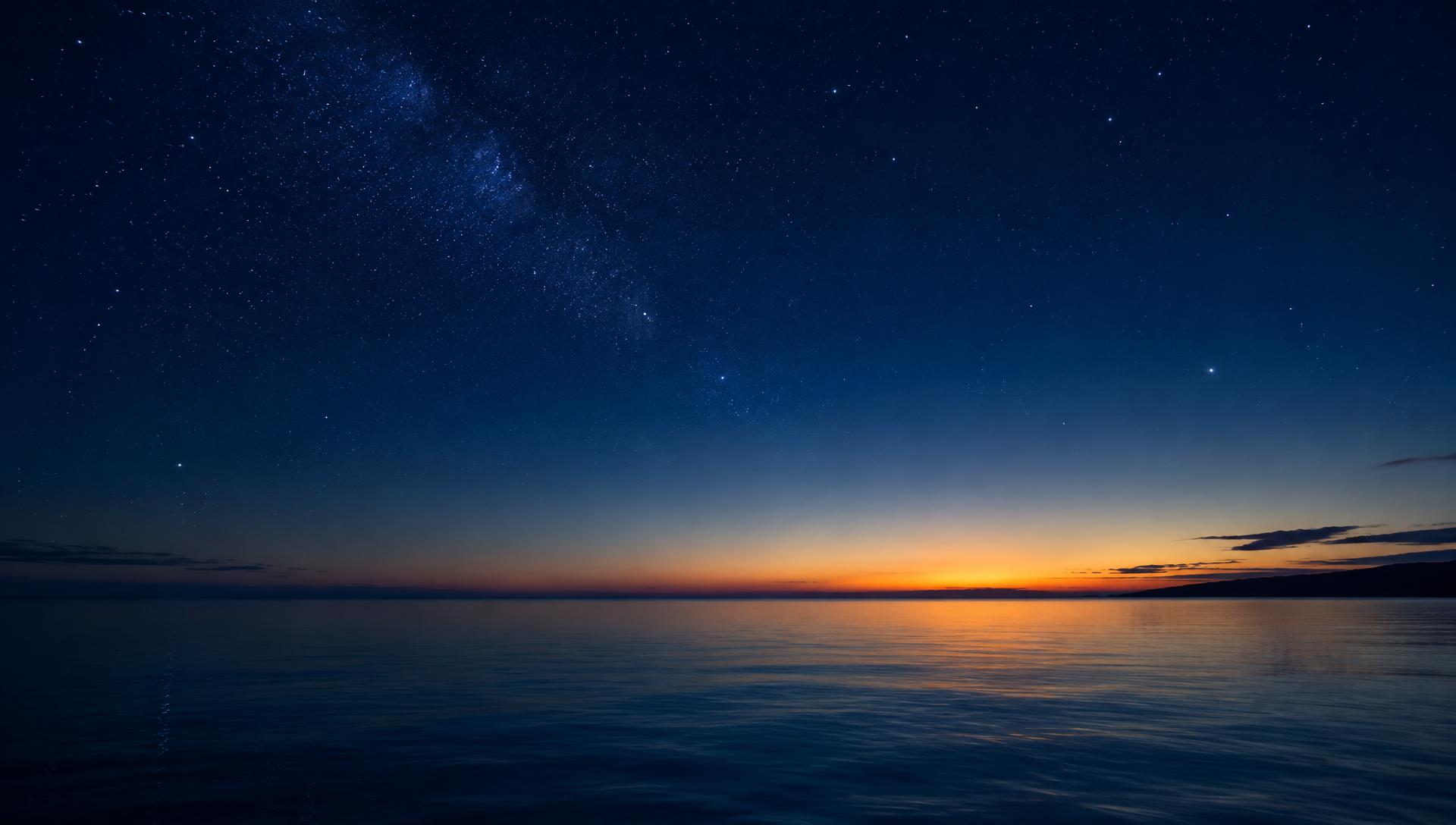 A deep navy night sky scattered with soft stars